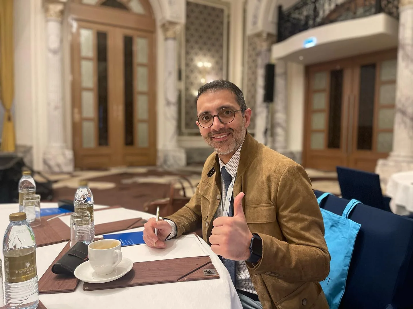 Dr. Öğr. Üyesi Şehriyar Nazari bir toplantı salonunda otururken